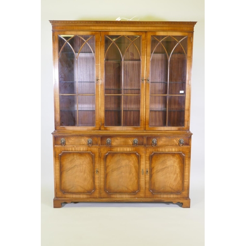 1012 - A Georgian style mahogany bookcase/display cabinet, the upper section with dentil cornice, astragal ... 