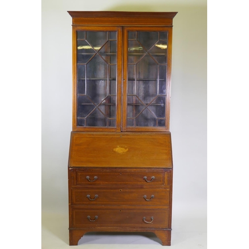 1014 - A Victorian mahogany bureau bookcase with a astral glazed top, the fall front fitted with pigeon hol... 