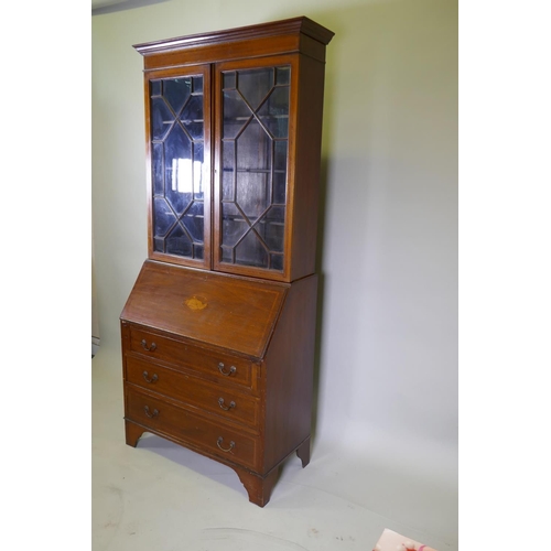 1014 - A Victorian mahogany bureau bookcase with a astral glazed top, the fall front fitted with pigeon hol... 