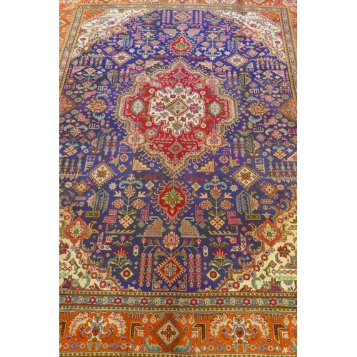 1018 - Large Persian carpet on a rich blue ground and multicolour field, with burnt orange border, Tabriz, ... 