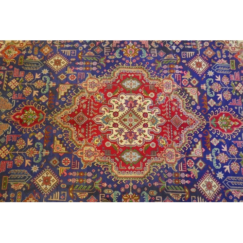 1018 - Large Persian carpet on a rich blue ground and multicolour field, with burnt orange border, Tabriz, ... 