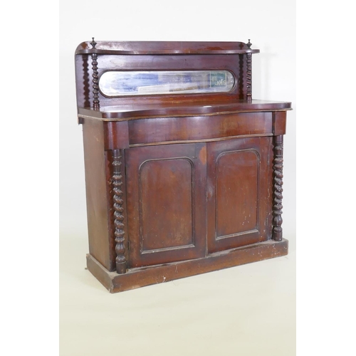 1021 - A Victorian mahogany serpentine front chiffonier, with mirrored back under a shelf, single frieze dr... 