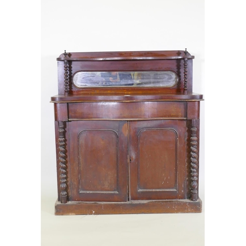 1021 - A Victorian mahogany serpentine front chiffonier, with mirrored back under a shelf, single frieze dr... 