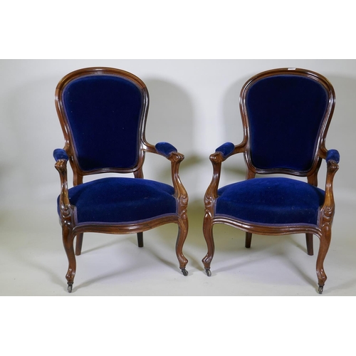 1027 - A pair of Victorian mahogany show frame arm chairs with faux bois grain painted decoration, raised o... 