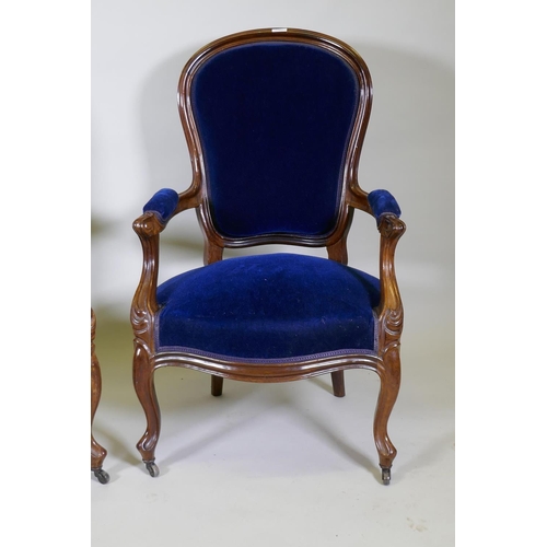 1027 - A pair of Victorian mahogany show frame arm chairs with faux bois grain painted decoration, raised o... 