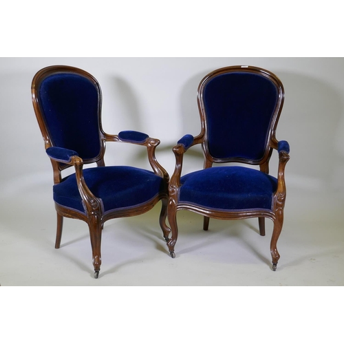 1027 - A pair of Victorian mahogany show frame arm chairs with faux bois grain painted decoration, raised o... 