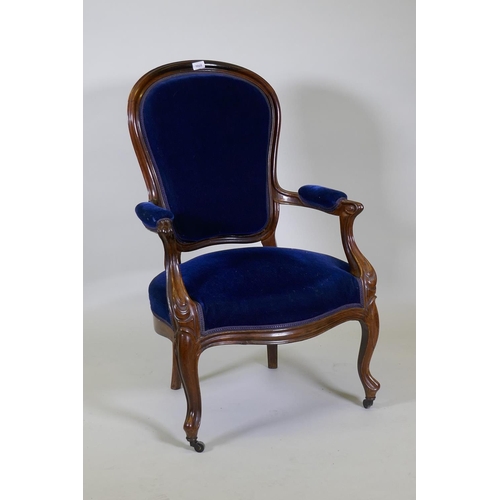 1028 - A Victorian mahogany show frame arm chair with faux bois grain painted decoration, raised on cabriol... 