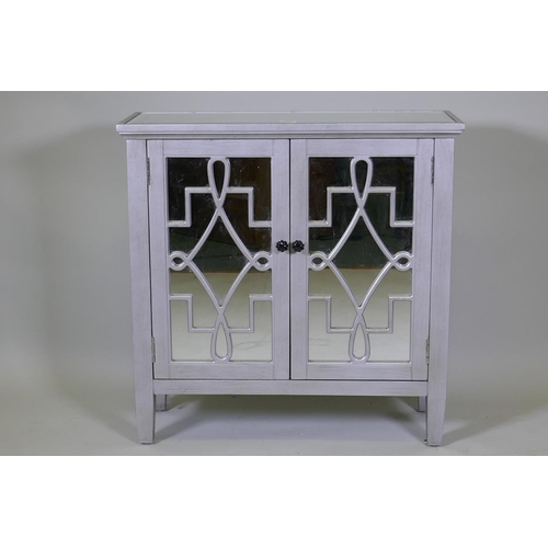 1033 - A contemporary silver leafed side cabinet with mirror glass top and cupboard doors, 82 x 30 x 82cm