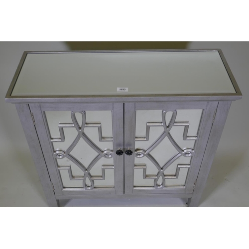 1033 - A contemporary silver leafed side cabinet with mirror glass top and cupboard doors, 82 x 30 x 82cm