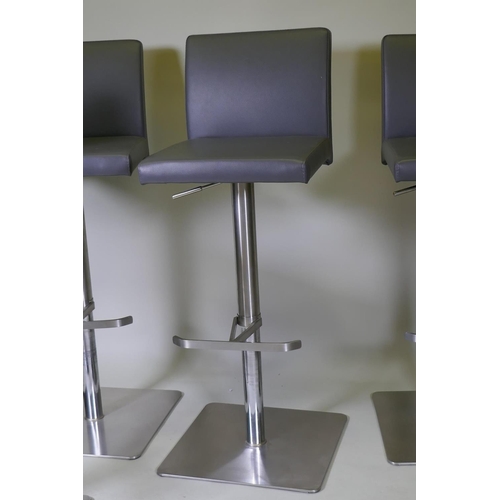 1034 - A set of five brushed steel swivel and height adjustable kitchen bar stools, 105cm extended