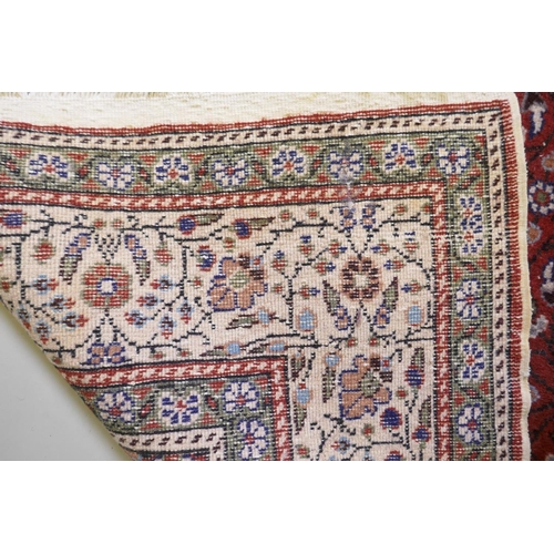 1037 - A terracotta ground wool pile Turkish Erikeh rug with all over design,200 x 290cm