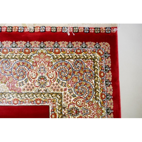 1038 - A rich ruby red ground full pile Qum rug with floral medallion pattern, 158 x 234cm