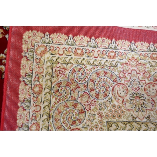 1038 - A rich ruby red ground full pile Qum rug with floral medallion pattern, 158 x 234cm