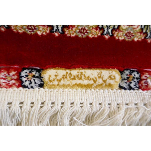 1038 - A rich ruby red ground full pile Qum rug with floral medallion pattern, 158 x 234cm