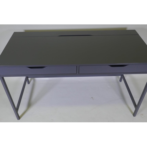 1042 - A contemporary two drawer desk with hinged flap and trunking holes for a PC, 132 x 60 x 76cm