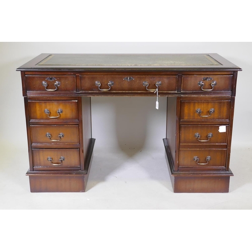 1044 - A Victorian style mahogany eight drawer pedestal desk, with leather inset top, raised on a plinth, 1... 