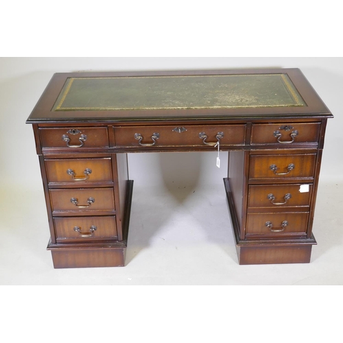 1044 - A Victorian style mahogany eight drawer pedestal desk, with leather inset top, raised on a plinth, 1... 