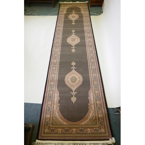 1045 - A deep black ground fine woven full pile Iranian runner with multicolour design, 100 x 408cm