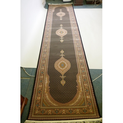 1045 - A deep black ground fine woven full pile Iranian runner with multicolour design, 100 x 408cm