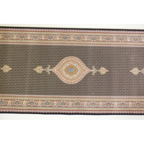 1045 - A deep black ground fine woven full pile Iranian runner with multicolour design, 100 x 408cm