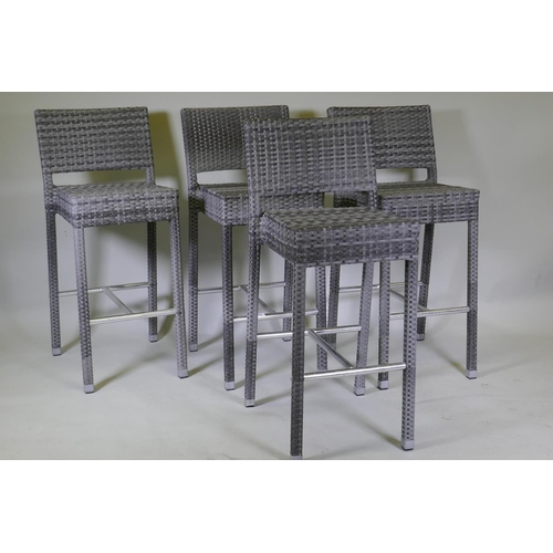 1046 - A set of four cane bar stools on chrome supports, 105cm high