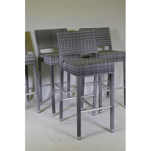 1046 - A set of four cane bar stools on chrome supports, 105cm high