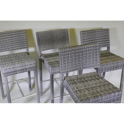 1046 - A set of four cane bar stools on chrome supports, 105cm high