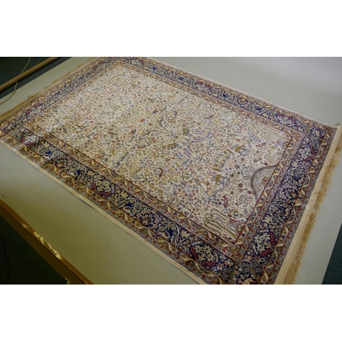 1050 - An ivory ground Kashmir full pile rug with tree of life design with blue borders, 158 x 234cm