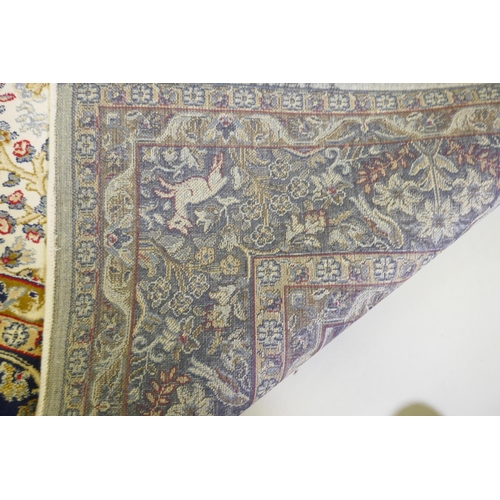 1050 - An ivory ground Kashmir full pile rug with tree of life design with blue borders, 158 x 234cm