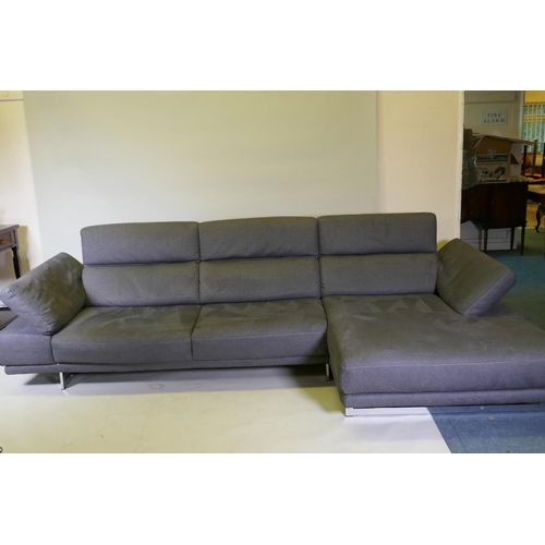 1052 - A Natuzzi corner sofa in two sections, with adjustable arms and backs, and textile upholstery, 316 x... 