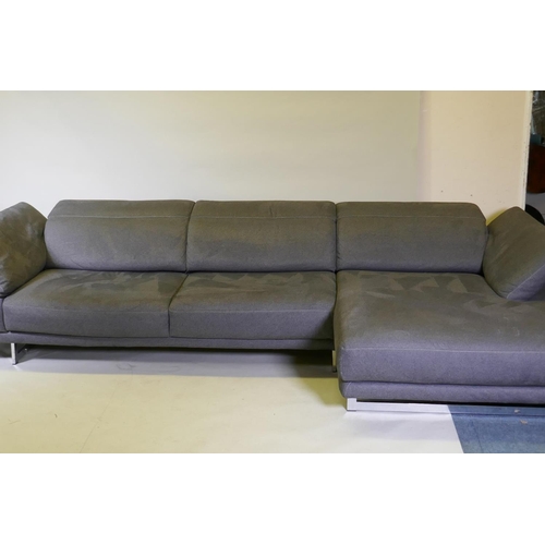 1052 - A Natuzzi corner sofa in two sections, with adjustable arms and backs, and textile upholstery, 316 x... 