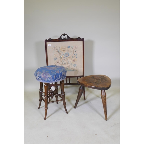 1055 - A Victorian beech wood stool, raised on sabre supports, 55cm high, another carved with an heraldic l... 