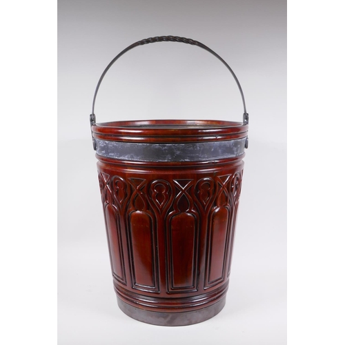 1066 - A Gothic style carved fruitwood and metal bound peat bucket, 47cm high, 39cm diameter