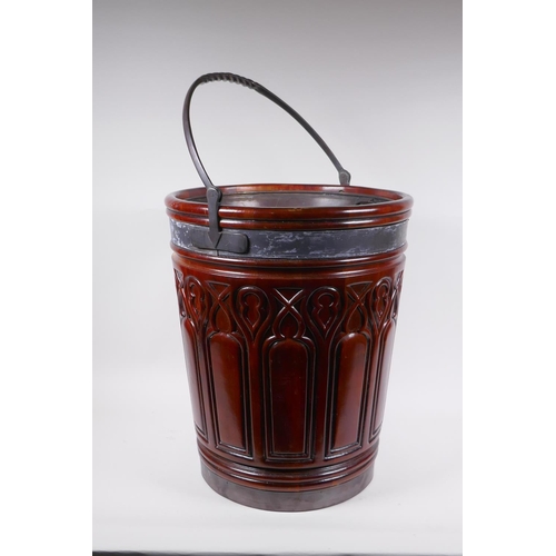 1066 - A Gothic style carved fruitwood and metal bound peat bucket, 47cm high, 39cm diameter