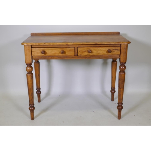 1070 - A satin birch two drawer writing table raised on turned tapered supports, 91 x 48cm, 75cm high