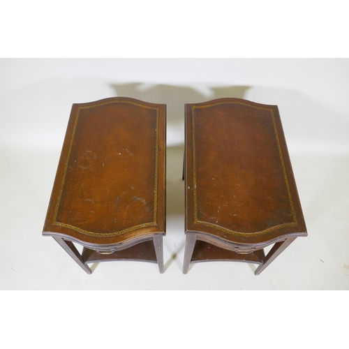 1073 - A pair of mahogany end tables with a single drawer, leather inset tops, tapered legs and an under ti... 