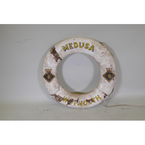 1080 - An antique cork and canvas lifebuoy, the Medusa, Weymouth, 74cm diameter