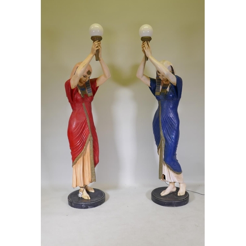 1082 - A pair of life size composition torchere lamps in the form of Egyptian maidens, 184cm high