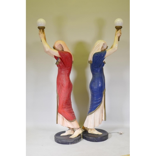 1082 - A pair of life size composition torchere lamps in the form of Egyptian maidens, 184cm high