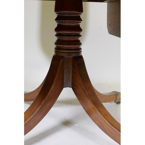 1084 - A George III mahogany pembroke table with single end drawer, raised on a turned column and splay sup... 