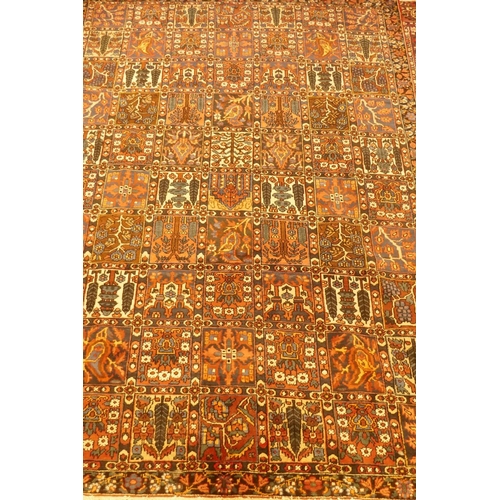 1097 - A Persian Bakhtiar multi-colour ground carpet, with Persian panel design, 335 x 250cm