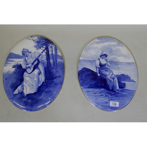 118 - A pair of Royal Doulton blue and white painted porcelain plaques with gilt rims, 36cm long