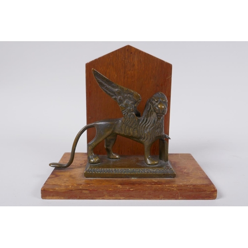 119 - A mahogany letter rack mounted with a bronze griffin, 14cm high