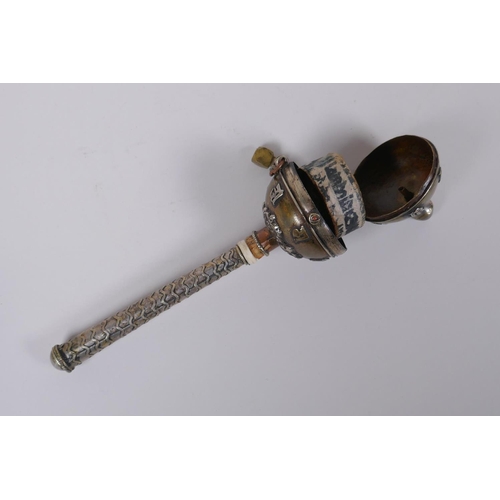 123 - A Tibetan bronze and silvered metal prayer wheel with raised script decoration, 22cm