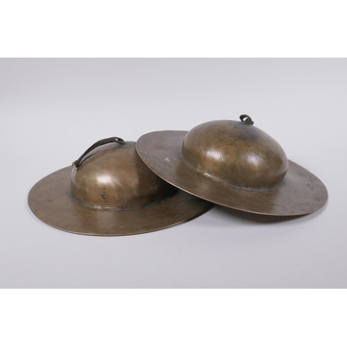 125 - A pair of Tibetan brass ceremonial 'Rol Mo' cymbals, 24cm diameter