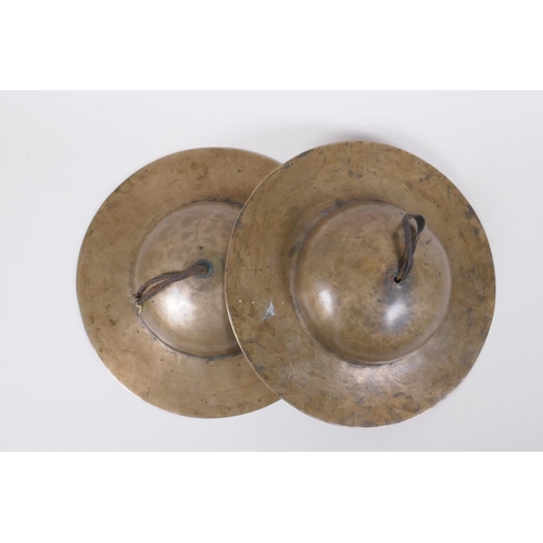 125 - A pair of Tibetan brass ceremonial 'Rol Mo' cymbals, 24cm diameter