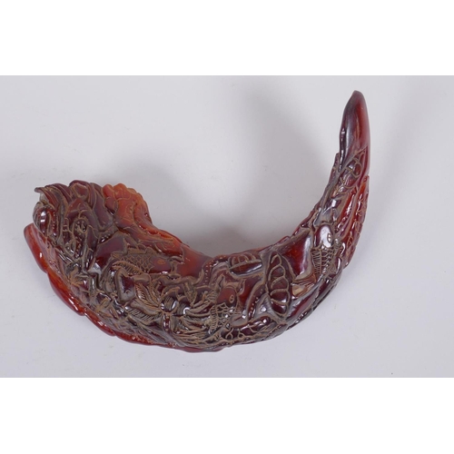 128 - A Chinese carved horn decorated with carp in a lotus pond 21cm wide