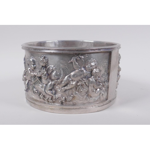 129 - A silvered composition pot with raised putti decoration, 20cm diameter