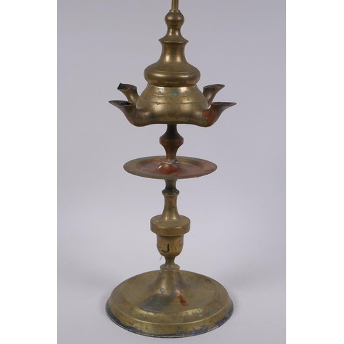 131 - An antique brass four spout whale oil lamp, 65cm high