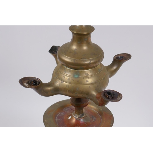 131 - An antique brass four spout whale oil lamp, 65cm high